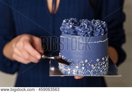 The Process Of Making Cake. Girls Hands Line With A Cream Scraper On A Round Cheesecake. Confectione