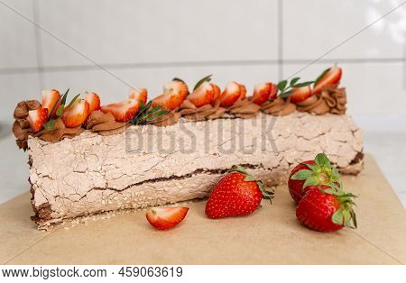 Sponge Roll Stuffed With Strawberry Cream. Homemade Cake Roll With Strawberry Cream. Chocolate Straw
