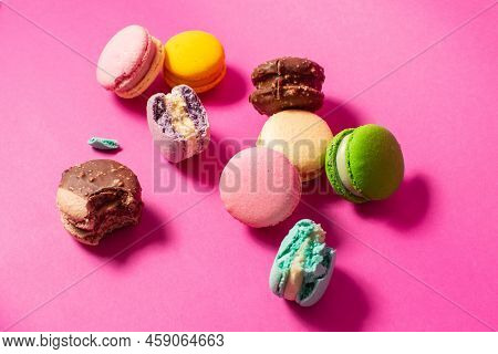 Bright Colorful Various Flavor Macarons Sweet Cookies On High-colored Pink Background.