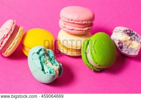 Bright Colorful Various Flavor Macarons Sweet Cookies On High-colored Pink Background.