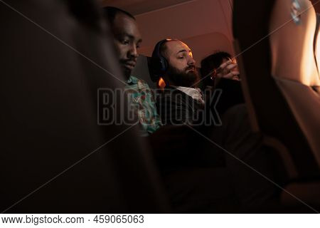 People Travellers Flying In Economy Class With Airplane Jet, Using International Airways Service On 
