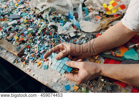 Man Mosaics Master Chooses Select Smalt Glass Pieces For Mosaic Panel. Male Mosaicist At Work