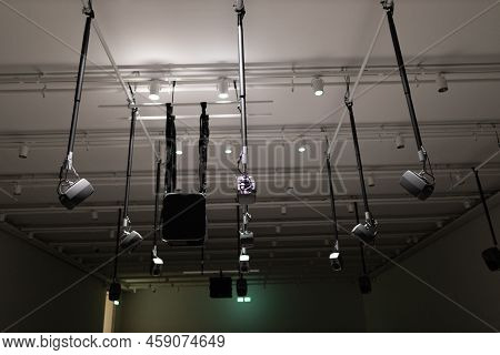 Young Man Listening To Sound Music Surround Installation With Many Speakers Above