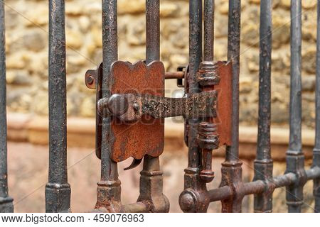 Ancient Metal Rusty Wrought Handle Deadbolt (latch) Of Closed Door Of The Lattice Gate Of The Antiqu