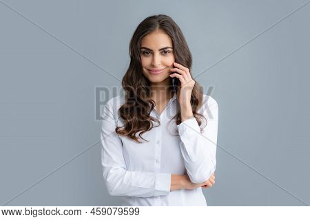 Girl Talking On Phone. Smiling Young Brunette Business Woman Girl In Shirt Isolated On Gray Backgrou