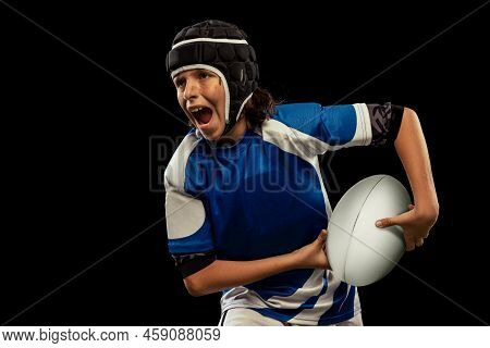Dynamic Portrait Of School Age Boy, Junior Male Rugby Player Practicing Rugby Football Isolated On D