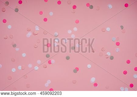 Party Colorful Confetti Over Pink Background . Top View, Flat Lay