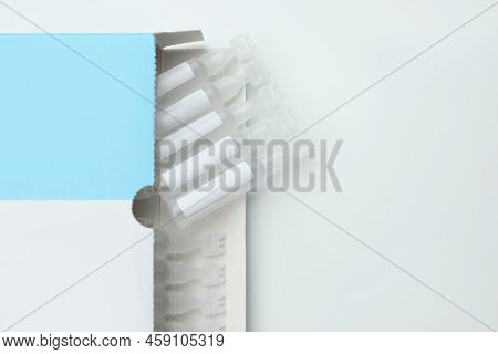 Package With Single Dose Ampoules Of Sterile Isotonic Sea Water Solution On White Background, Top Vi