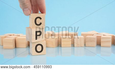 Hand Holding Wood Cube Block With Text Cpo - Cost Per Order. The Inscription On The Cubes Is Reflect
