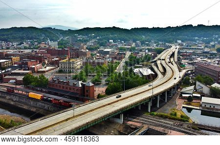 Interstate 68 Crossing Over Cumberland, Maryland With Trains And Many Buildings