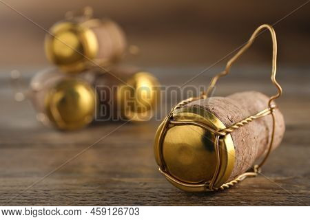 Cork Of Sparkling Wine And Muselet Cap On Wooden Table, Closeup. Space For Text