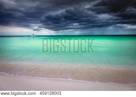 Dramatic Sky With Storm Clouds Over Caribbean Beach With Motorboat, Negril Seven Mile Beach, Jamaica