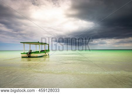 Dramatic Sky With Storm Clouds Over Caribbean Beach With Motorboat, Negril Seven Mile Beach, Jamaica