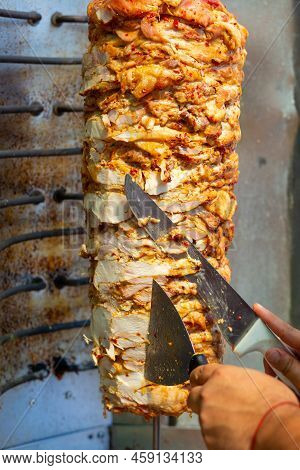 Chef Cutting With Doner Knife Traditional Turkish Doner Kebab Meat.