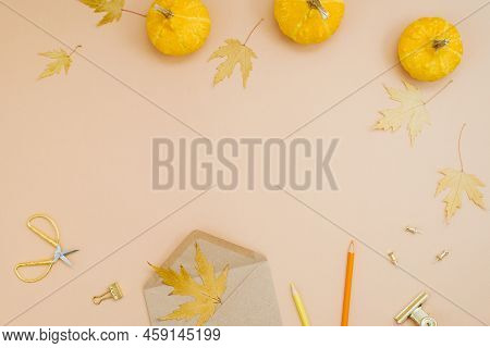 Autumn Background With Yellow Pumpkins, Fallen Leaves, Cookies, Crayons, Eon And A Pen. Workplace Fo