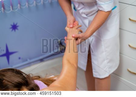 Facial Massage. A Woman Is Given A Massage In A Beauty Salon. Close-up.