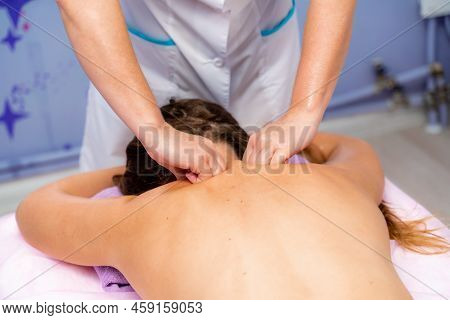 Facial Massage. A Woman Is Given A Massage In A Beauty Salon. Close-up.