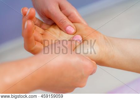 Facial Massage. A Woman Is Given A Massage In A Beauty Salon. Close-up.