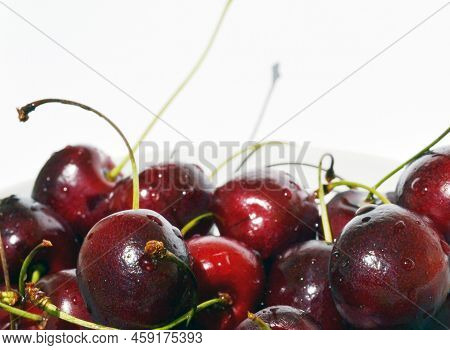 Cherry In A Bowl On A White Background. The Photo Shows Cherries In A Bowl On A White Background, Ma