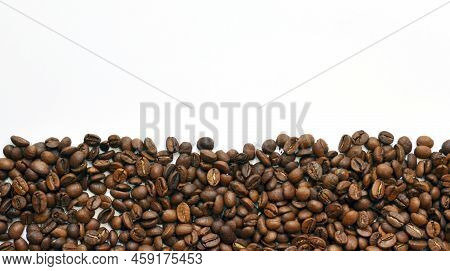 Coffee Beans On A White Background. The Photo Shows Some Grains On A White Background, A Photo For T