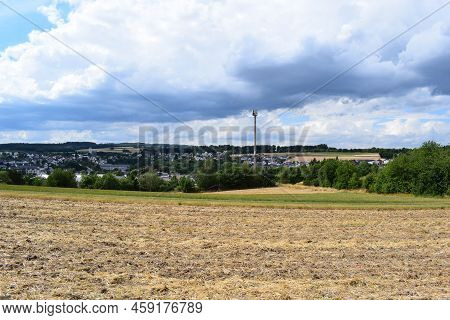 Eifel Landscape With A Mobile Phone And Web Service Transmitter Above A Small Town