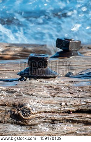 Waves Crashing And Spraying Over A Freshwater Shipwreck Remains With Large Bolts