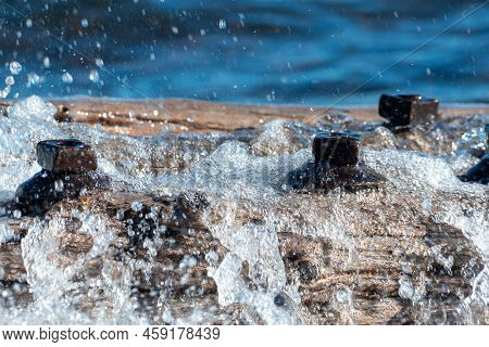 Waves Crashing And Spraying Over A Freshwater Shipwreck Remains With Large Bolts