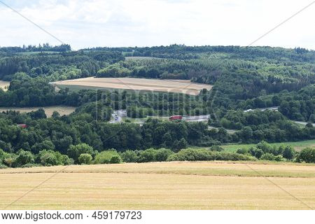 Eifel Landscape With The Autobahn A48 And Passing Vehicles