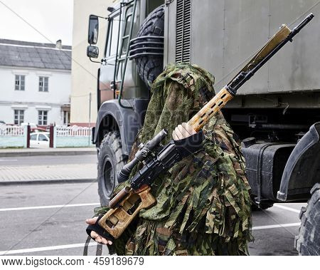 Close-up Portrait Of A Military Sniper In Camouflage Green Army Clothes With A Degtyarev Sniper Rifl