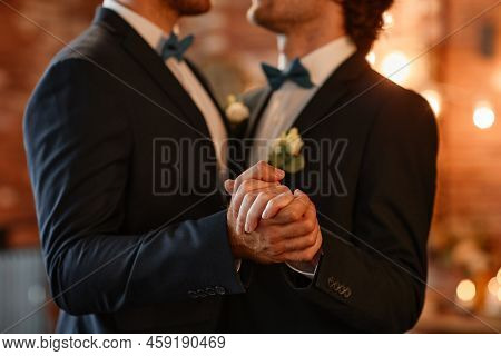 Close Up Of Male Gay Couple Dancing Together During Wedding Ceremony And Holding Hands, Copy Space