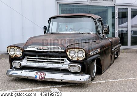 Hasselt, Belgium - June 24 2017: Black Retro Car Parked On Street Of Old European City On Cloudy Day