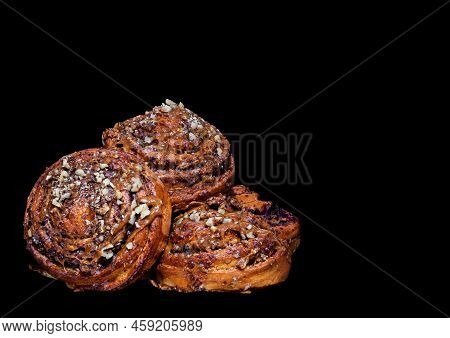 Image Of Fresh Delicious Buns With Nuts Cream And Poppy Seeds On Black Background