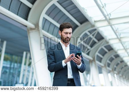 Business Man Standing Background A Modern Train Station Airport Or Bus Stop In Formal Suit With A Su