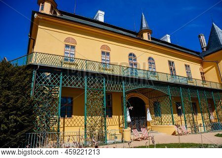 Slatinany, Czech Republic, 17 April 2022: Classical Chateau Or Romantic Yellow Castle Surrounded By 