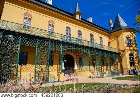 Slatinany, Czech Republic, 17 April 2022: Classical Chateau Or Romantic Yellow Castle Surrounded By 