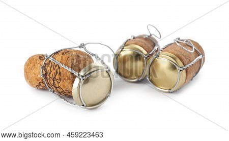 Corks Of Sparkling Wine And Muselet Caps On White Background
