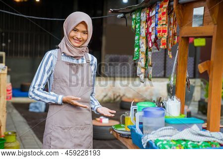 Woman Standing In Front Of Her Small Traditional Food Shop
