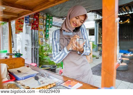 Muslim Seller Taking Order From Customer Through Phone