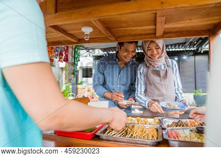 Muslim Couple Enjoy Having Iftar Dinner At Traditional Food Stall