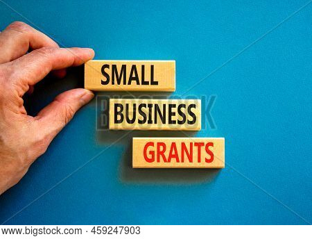 Small Business Grants Symbol. Concept Words Small Business Grants On Wooden Blocks On A Beautiful Bl