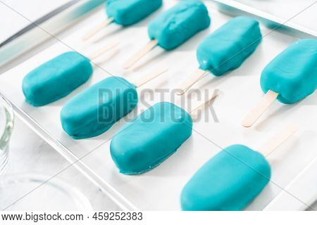 Decorating Cakesicles With Drizzled Chocolate, Chocolate Mermaid Tails, And Seashells.