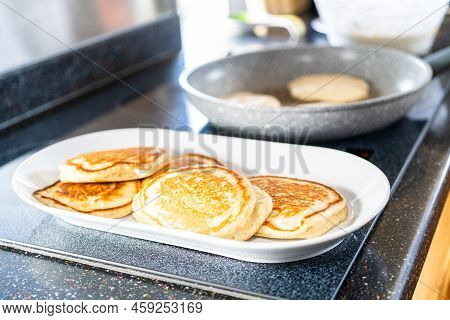 Frying Kefir Based Pancakes In Cooking Pan On An Electric Stove.