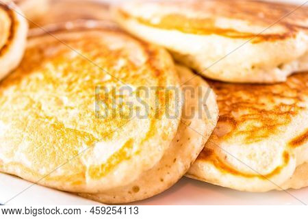 Freshly Made Pancakes On A White Serving Plate.