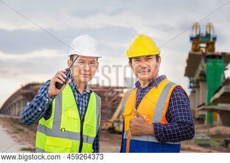 Engineer And Foreman Worker Checking Project At Building Site, Engineer And Builders In Hardhats Dis