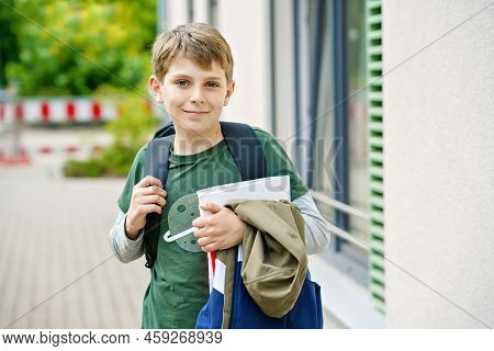 Happy Preteen Kid Boy With Backpack Or Satchel. Schoolkid In On The Way To Elementary Or Middle Scho