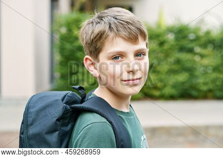 Happy Preteen Kid Boy With Backpack Or Satchel. Schoolkid In On The Way To Elementary Or Middle Scho