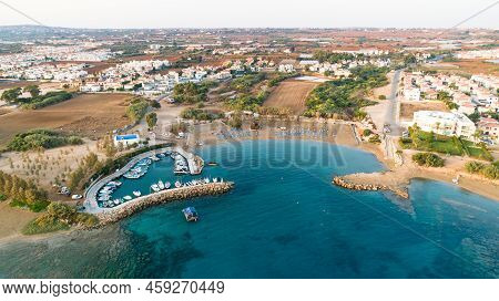 Aerial View Of Coastline Sunset And Landmark White Washed Chapel At Agia Triada Beach, Protaras, Fam
