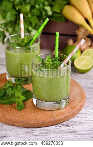 Fresh Organic Detox Green Drink Smoothie With Celery, Spinach, Banana, Cilantro, Lime And Ginger Wit