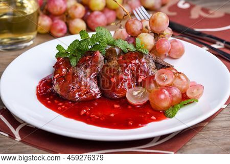 Warm Salad With Chicken Liver And Grapes On The Plate. Warm Salad From Turkey Liver. Warm Salad With