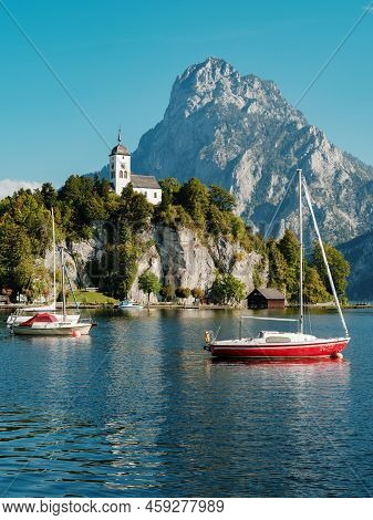 Scenic View On The Perched Johannesberg Chapel In Austria, Surrounded By Mountains And The Lake Trau